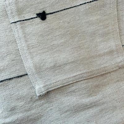 Close up of Taupe cotton woven apron with two front pockets