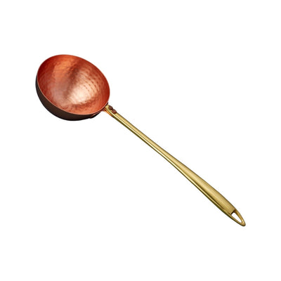 metal ladle with gold handle and copper spoonhead