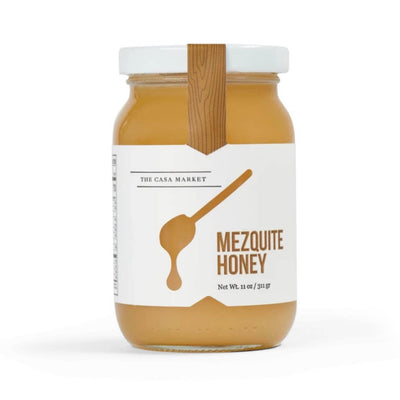Large Mezquite Honey in an 11 ounce jar with a white branded label that features a honey dipper.