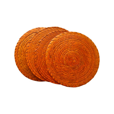 4 orange circular coasters made of palm