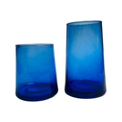 2 translucent blue colored drinking glasses in varying heights