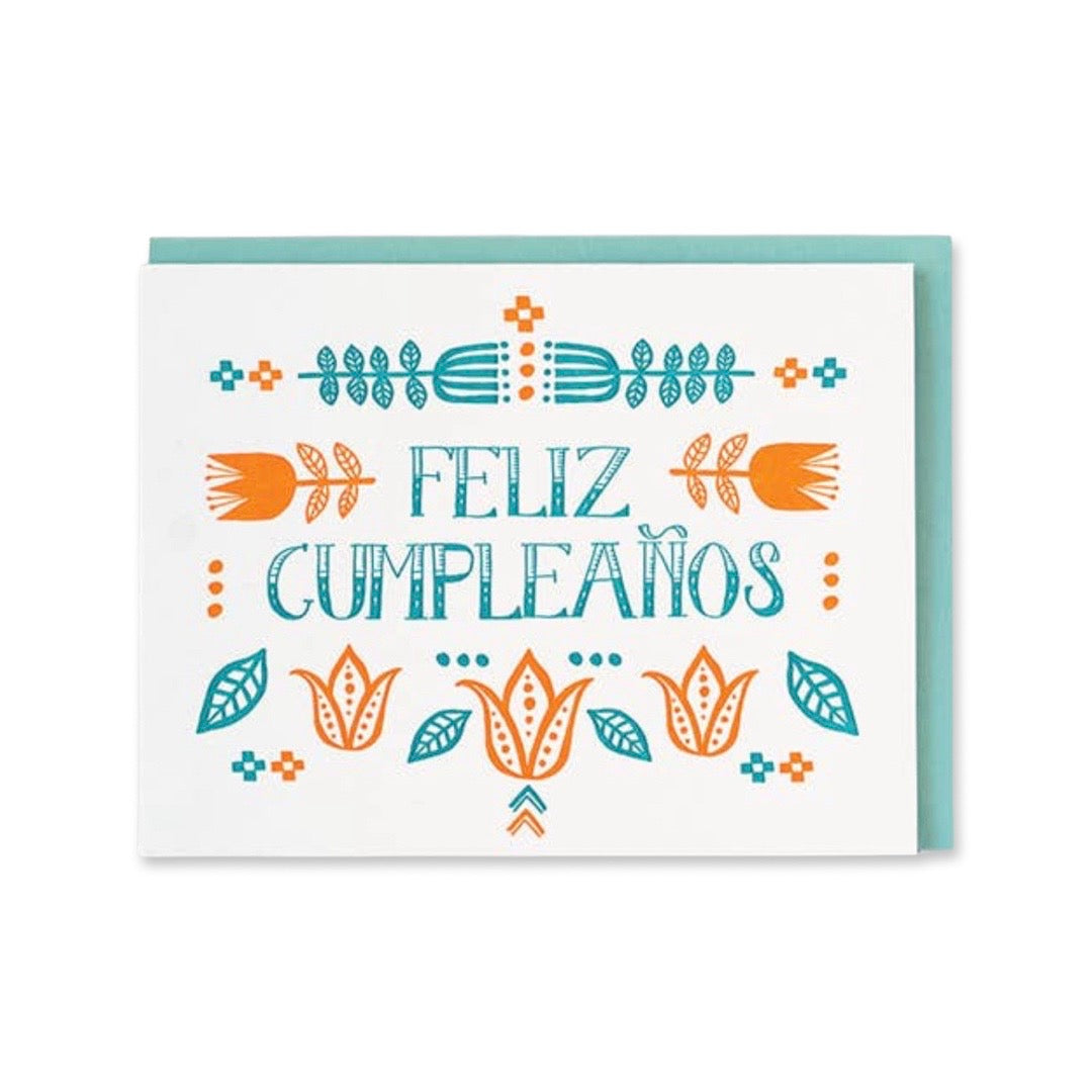 Greeting card reads: Feliz Cumpleanos, English Translation is Happy Birthday. Illustration features floral design surrounding text.
