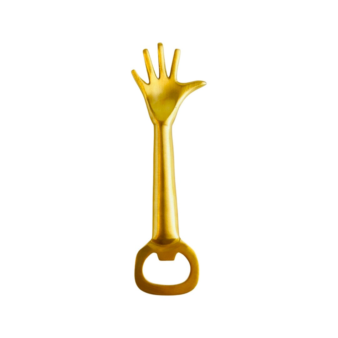 Gold colored metal bottle opener with hand shaped handle