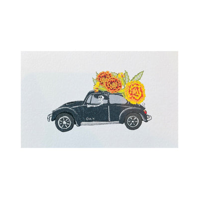 Postcard with an image of marigolds on top of a black Volkswagon Bug driven by a skeleton.