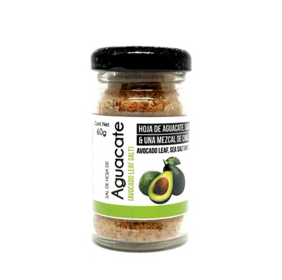 front view of Sal de Hoja Aquacate (Avocado Leaf Salt) in clear glass branded jar with black lid