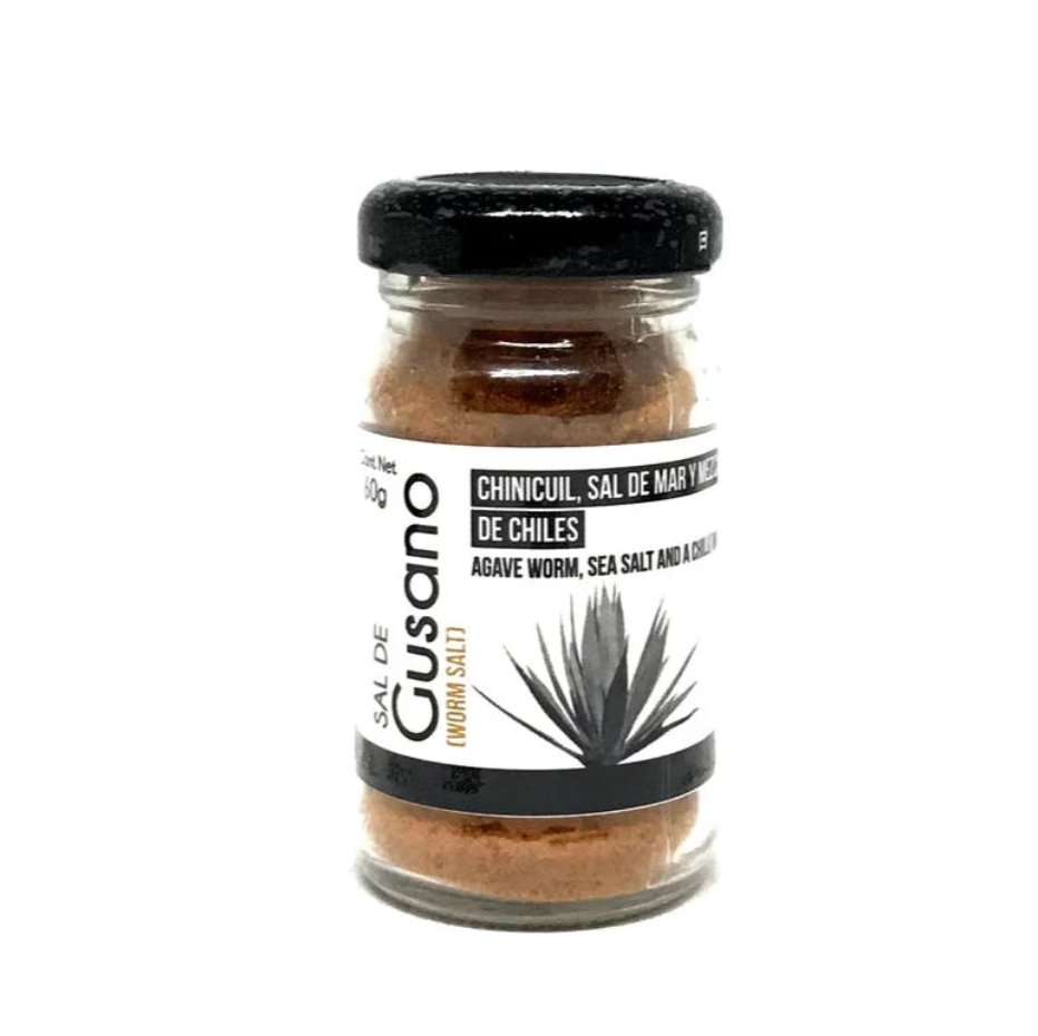 front view of Sal de Gusano (Worm Salt) in clear glass branded jar with black lid