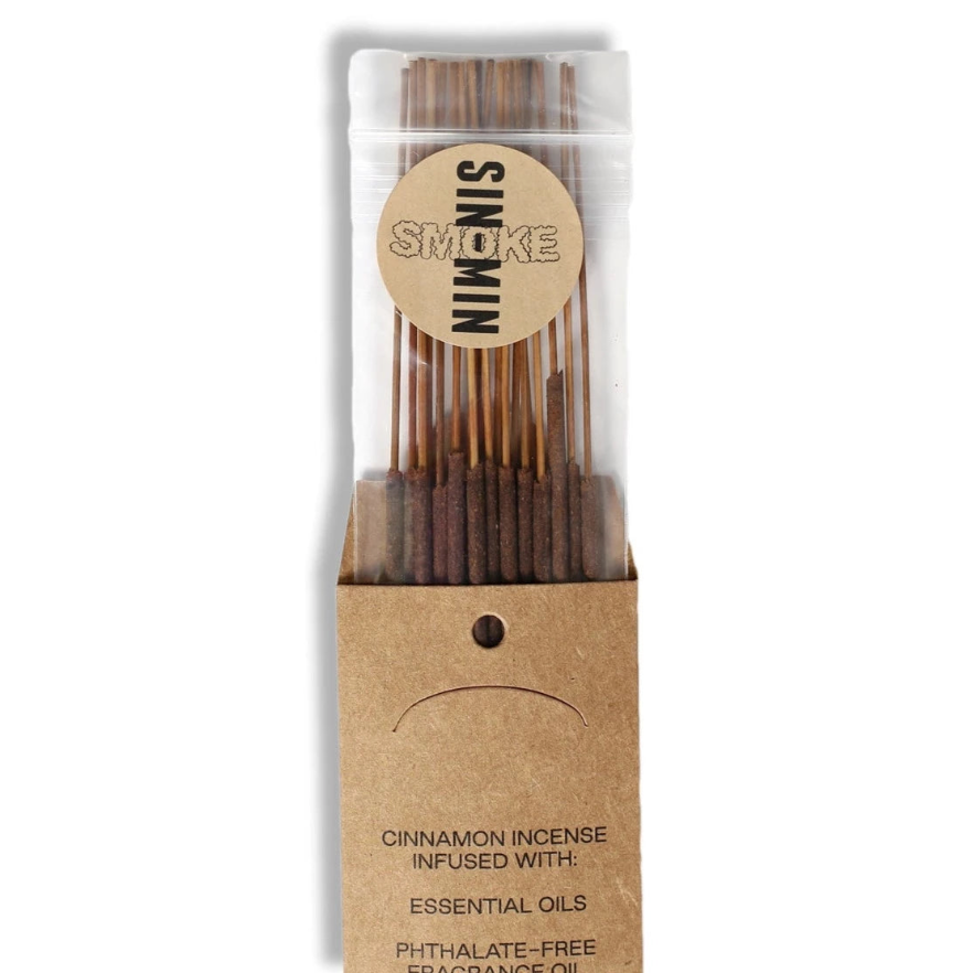 A bundle of cinnamon incense sticks in a clear branded packaging. 