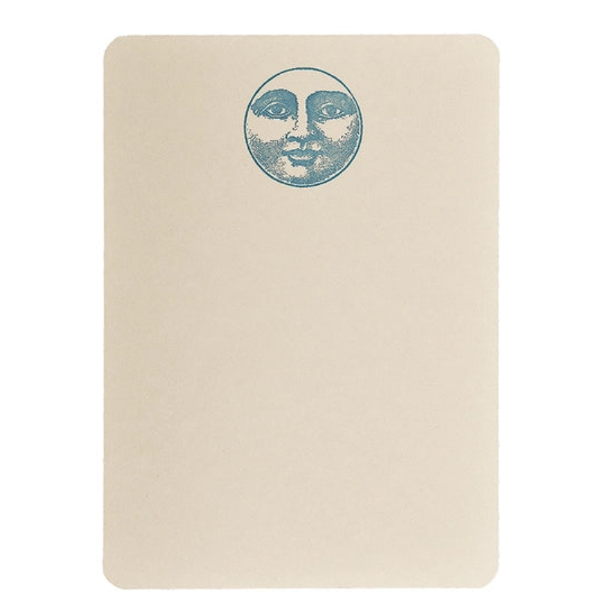 Notecard features moon with a face illustration at top center
