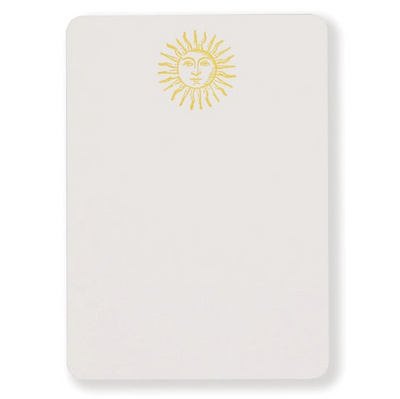 Notecard features sun with a face illustration at top center