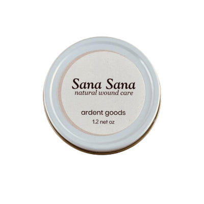Healing balm in 1.2 ounce white circular tin container.
