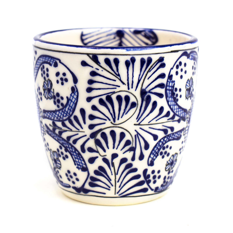White mug painted with blue designs