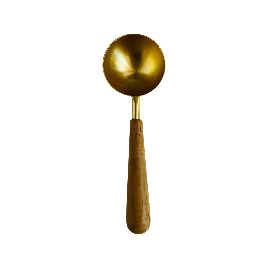 gold colored metal scoop with wood handle top view