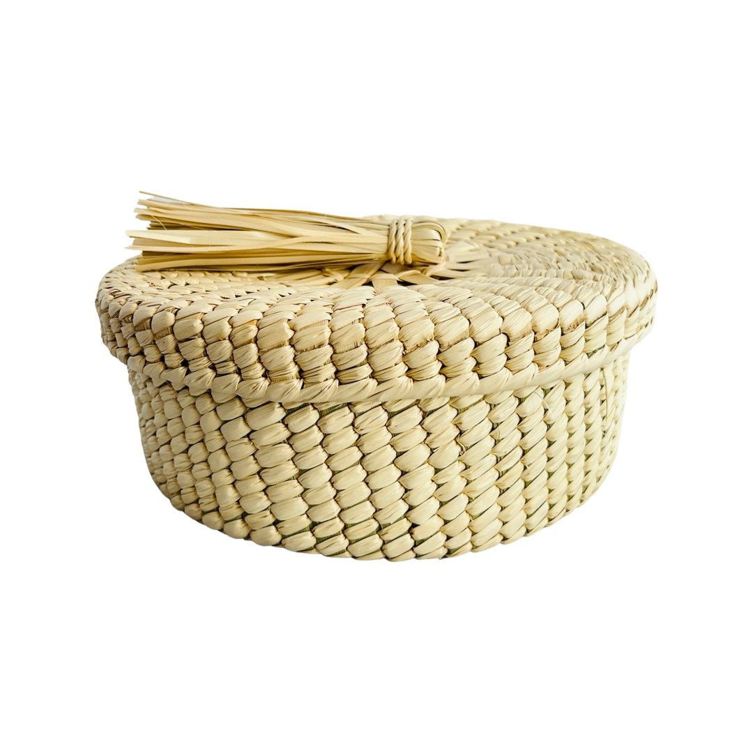 Mexican palm woven tortilla basket featuring a decorative palm tassle