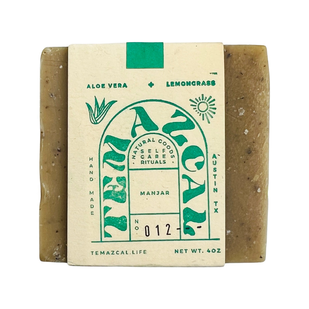Green bar of soap with branded packagaing.