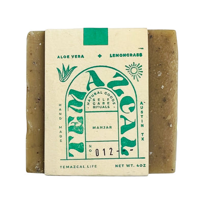 Green bar of soap with branded packagaing.