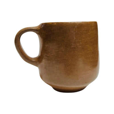 side view of brown clay mug, handle is shown