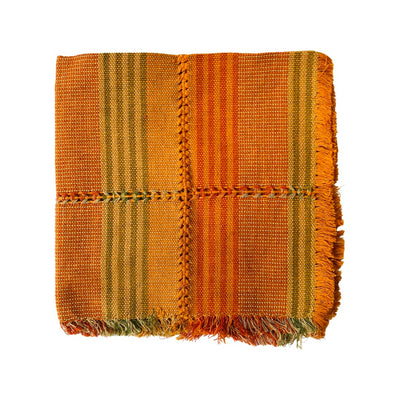 Woven cotton napkin with mustard, forest green and various shades of orange stripes.