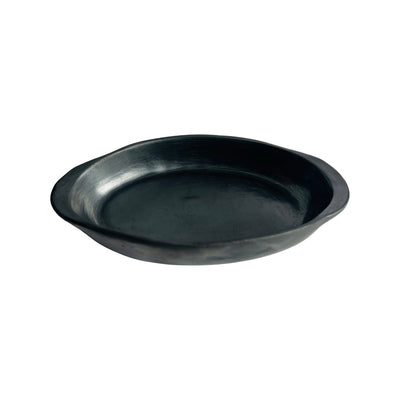Side view of a barro negro, black clay, cazuela (casserole dish).