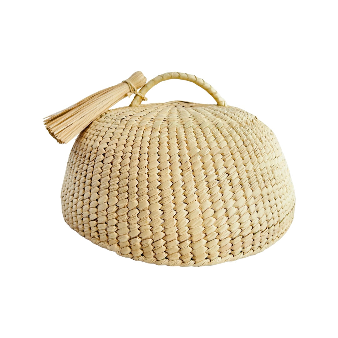 Dome shaped Mexican Woven Palm Cover with a handle and decorative palm tassle 