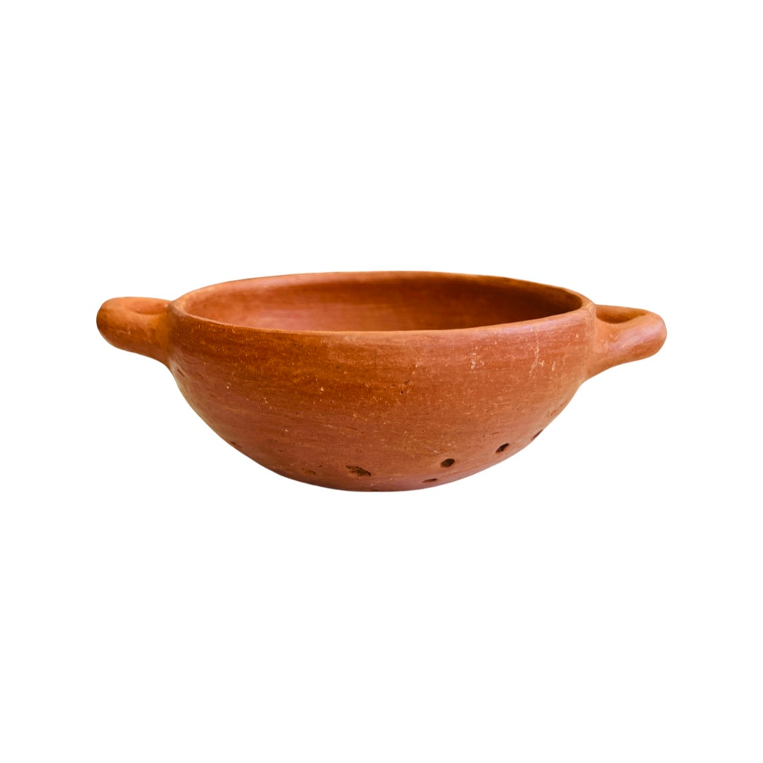 Side view of a barro rojo, or red clay, strainer with handles on both sides