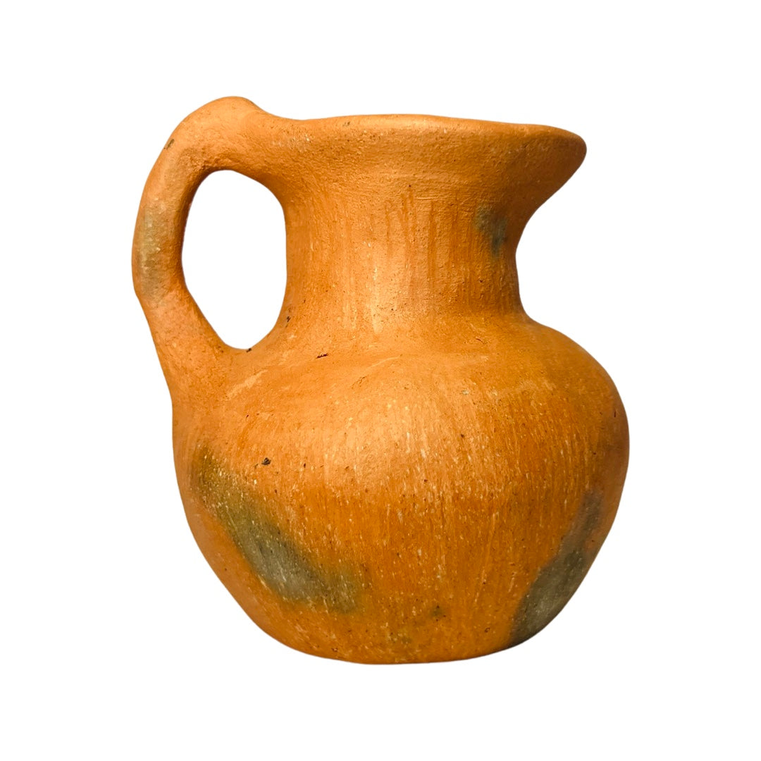 Side view of a barro rojo, red clay, mini pitcher