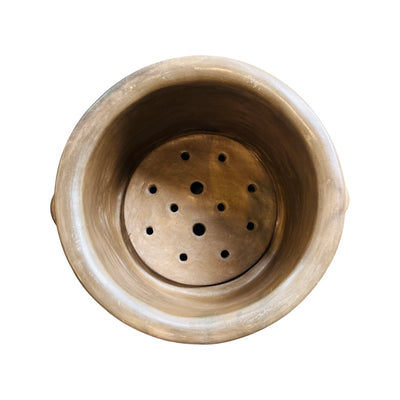 Top view of a light tan clay tamalero, or tamale steam pot.