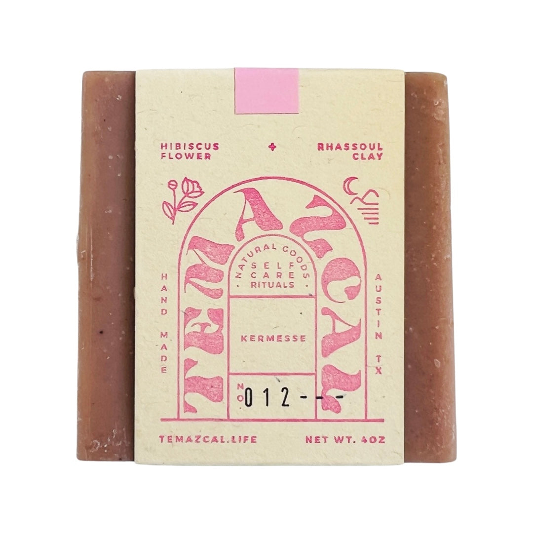 Pink bar of soap with branded wrapping.