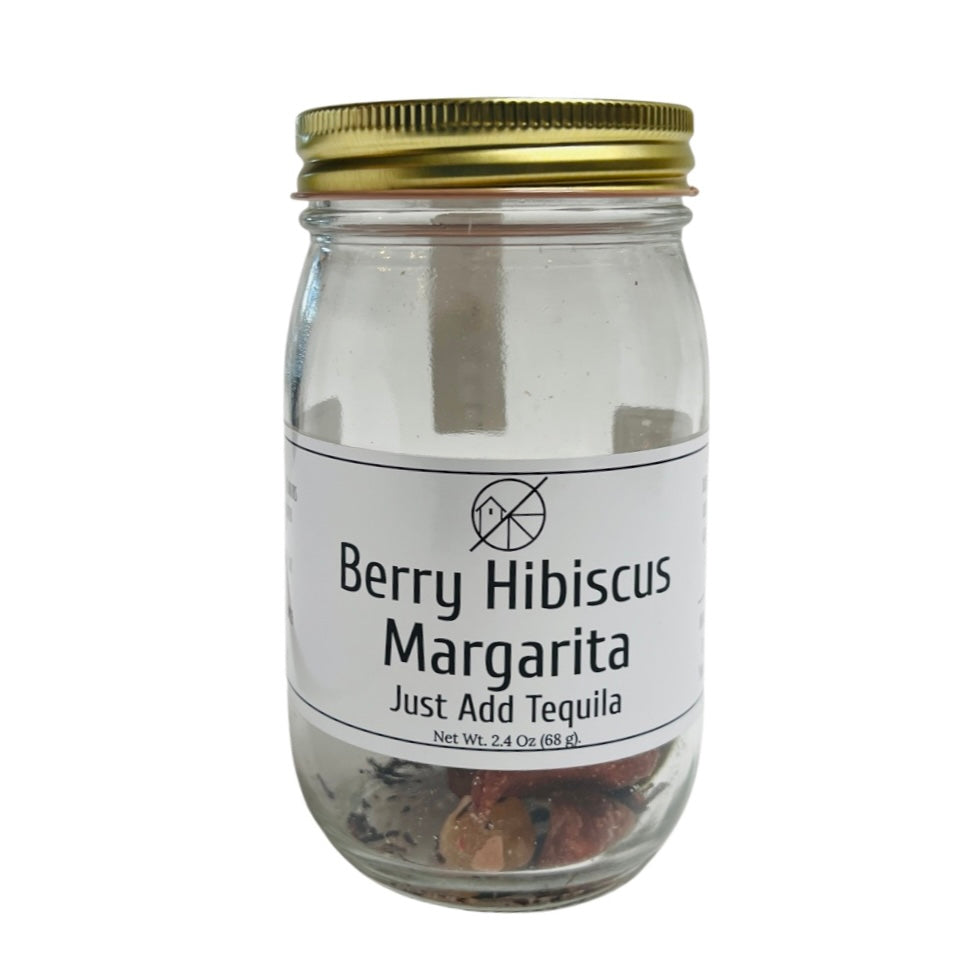 Clear 2.4 ounce mason jar of the Berry Hibiscus Margarita infusion kit that features dehydrated berries and hibiscus.
