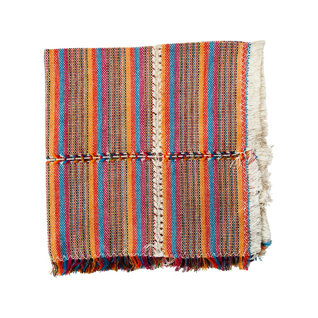 Woven cotton napkin with orange, blue, red and cream stripes.