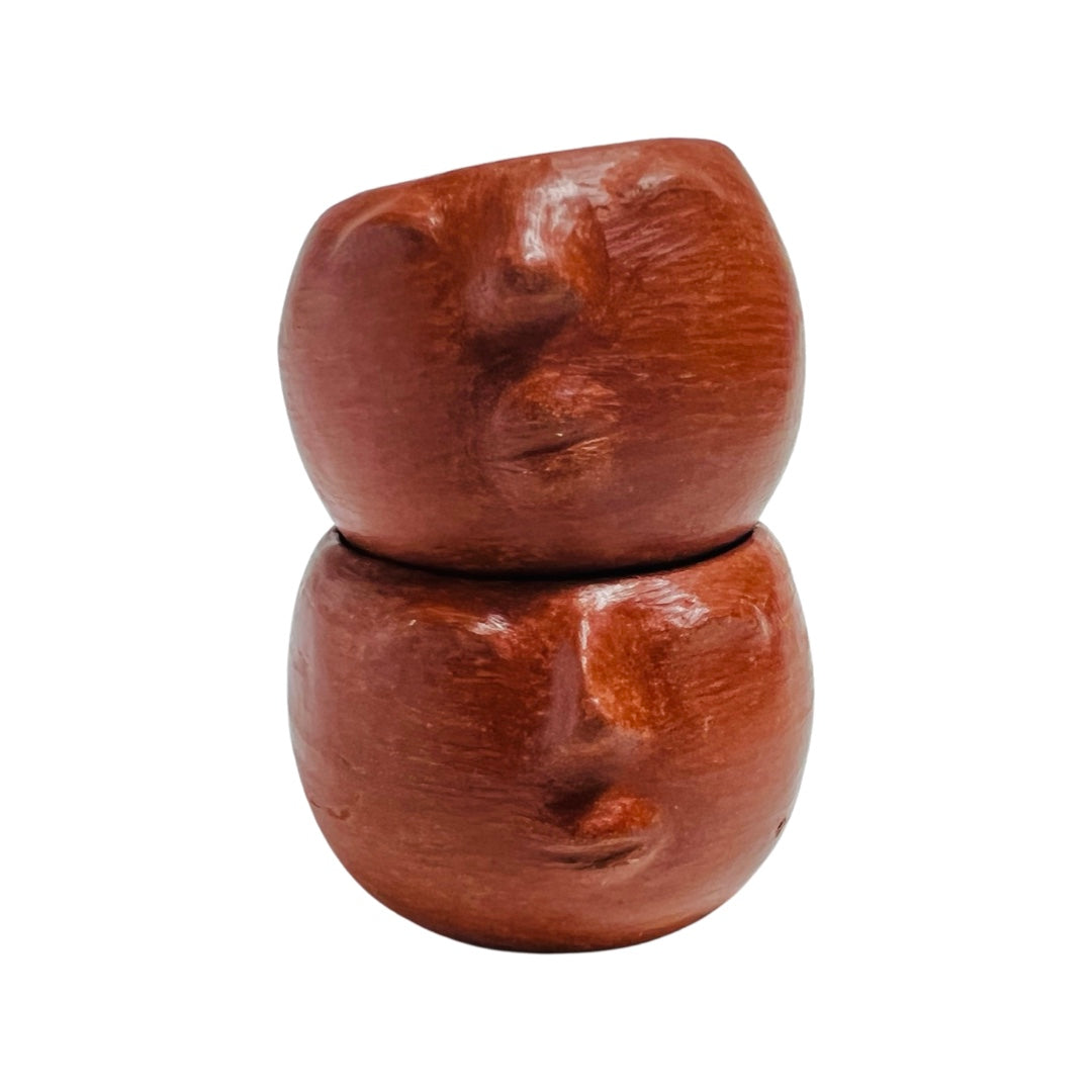 two stacked clay colored shot glasses hand sculpted with facial features