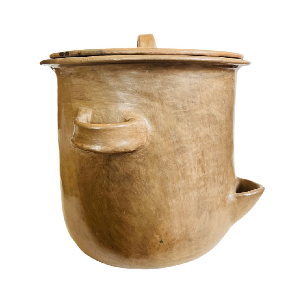 Side view of a light tan clay tamalero, or tamale steam pot, with handles.
