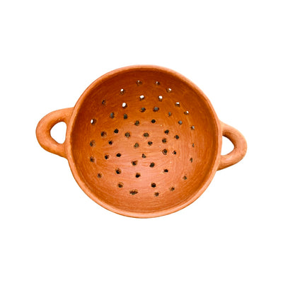 Top view of a barro rojo, or red clay, strainer with handles on both sides
