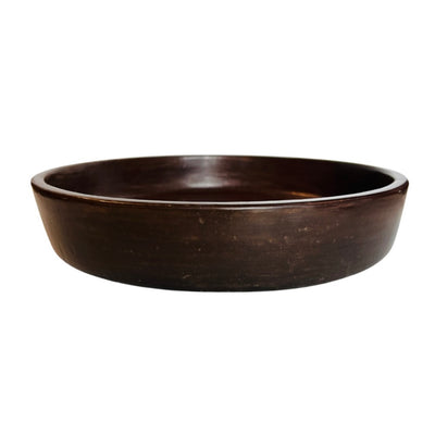 Side view of a brown clay bowl