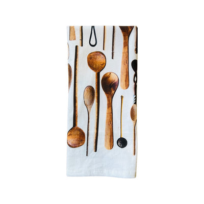Quarter folded white towel with various shapes and sizes of wooden spoons. 