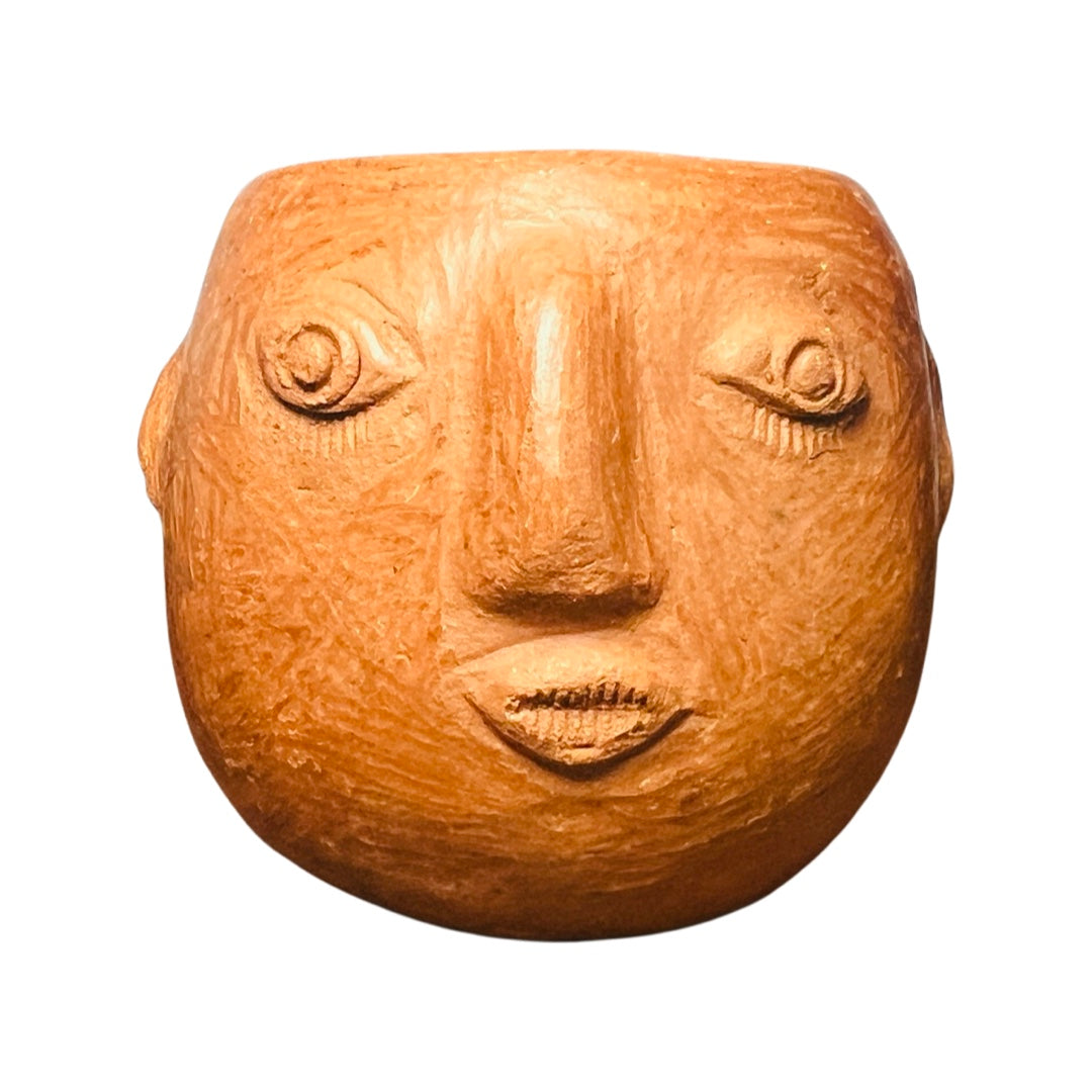 round red clay mezcal cup with a face