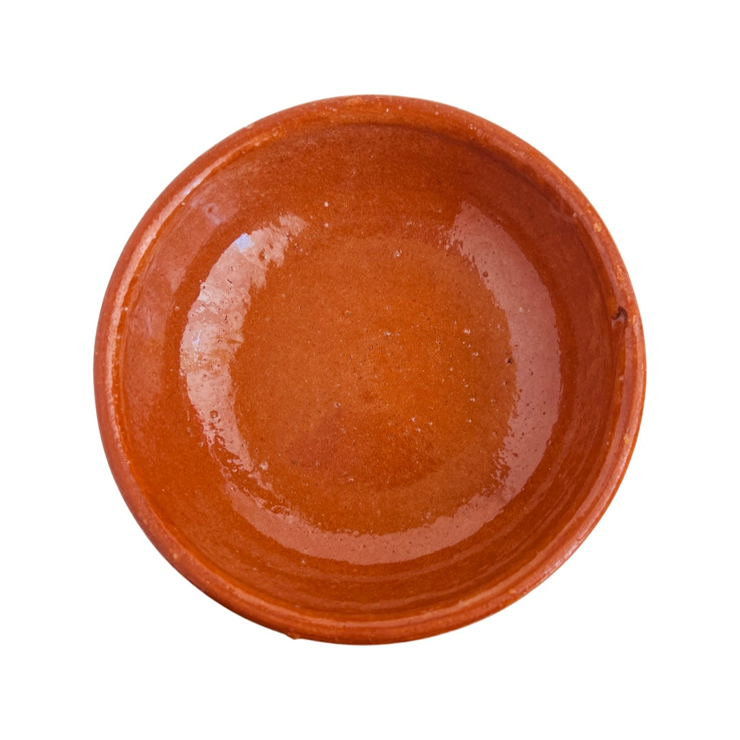 Birdseye view of glossy red clay salsa bowl.