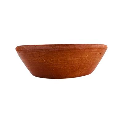 Front view of glossy red clay soup bowl.