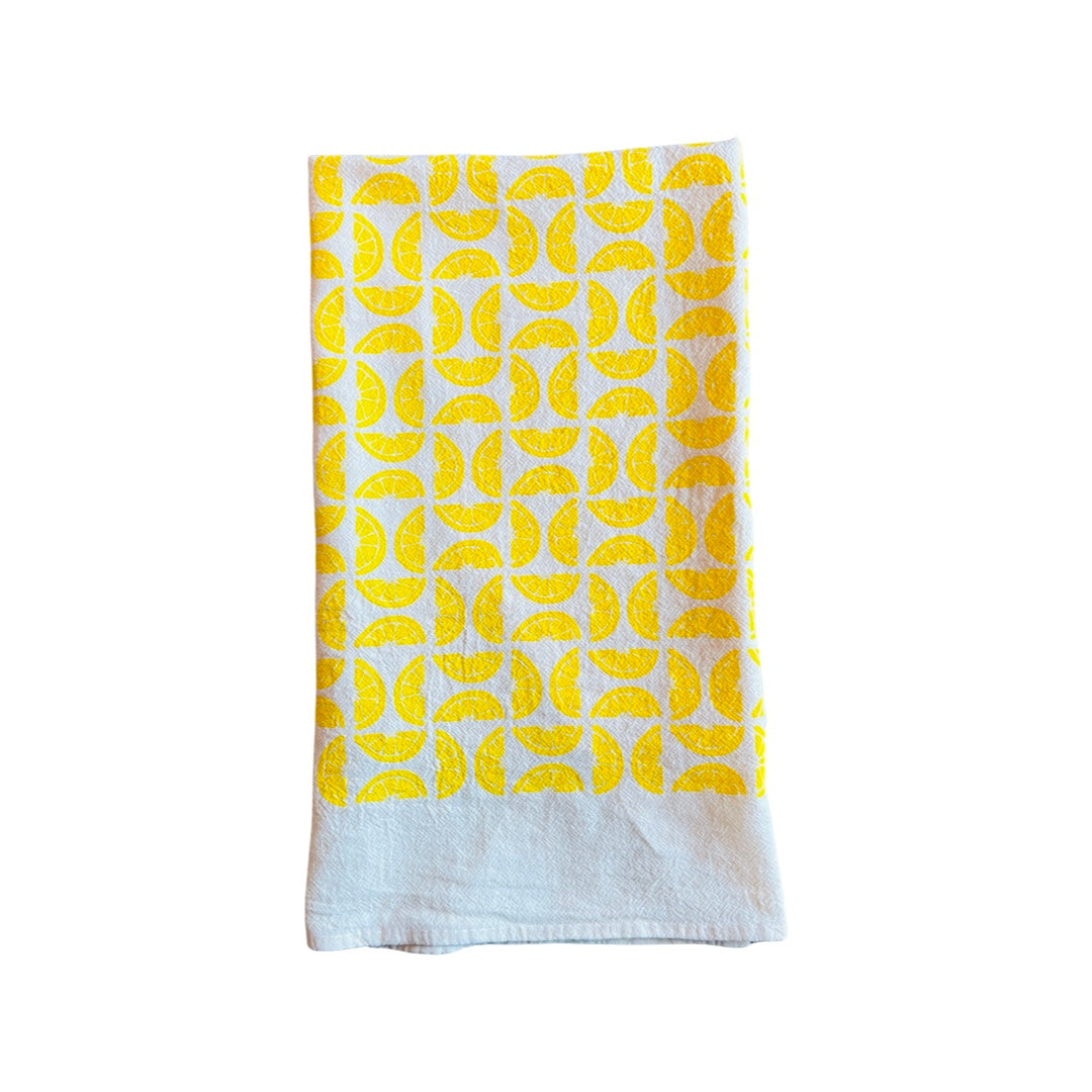 folded Lemons Tea Towel features graphic of sliced lemons.