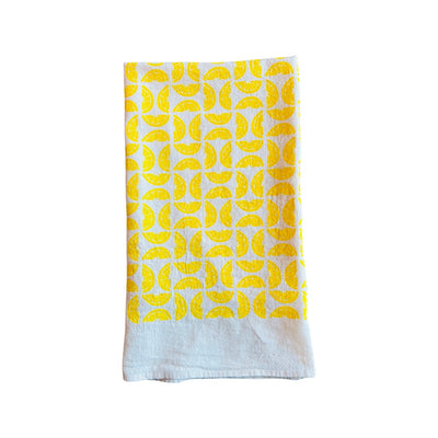 folded Lemons Tea Towel features graphic of sliced lemons.