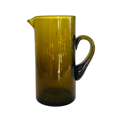 Front view of an amber colored pitcher with a handle.