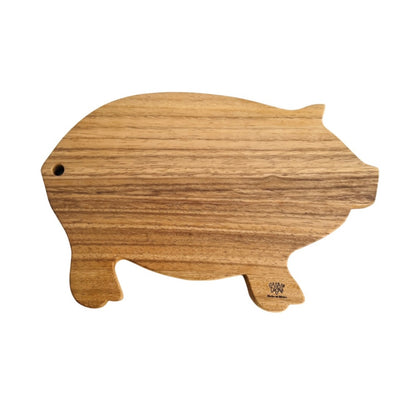 Wooden pig shaped cutting board with the phrase Casa Y Cocina engraved on the front hoof. Translation for Casa y cocina is Home and Kitchen. 