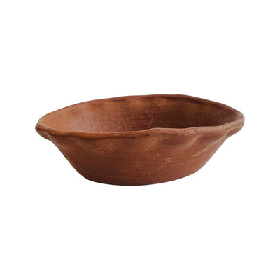 Side view of a red barro bowl